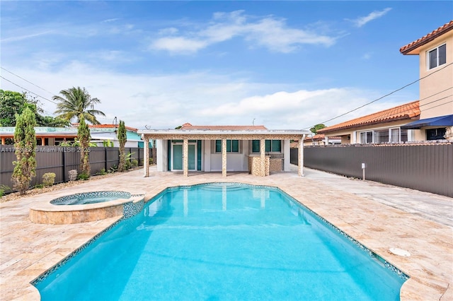 view of pool with a patio area and an in ground hot tub