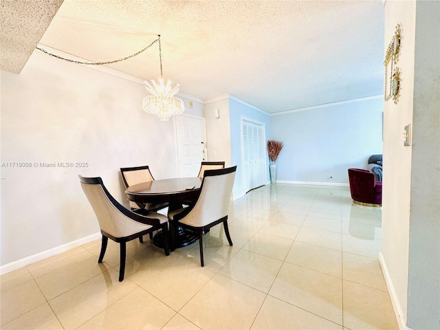 tiled dining room with a textured ceiling, a notable chandelier, and ornamental molding