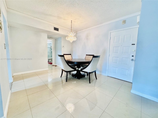 dining space with light tile patterned floors, a chandelier, a textured ceiling, and ornamental molding