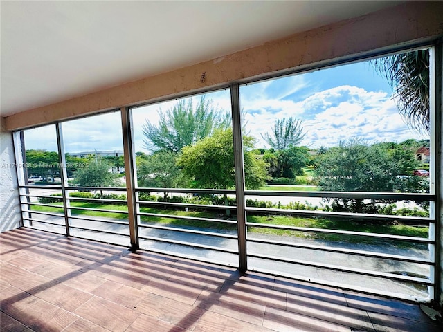 unfurnished sunroom with a water view