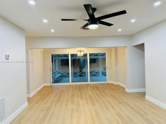 unfurnished living room featuring ceiling fan and light wood-type flooring