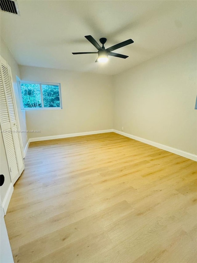 spare room with ceiling fan and light hardwood / wood-style floors