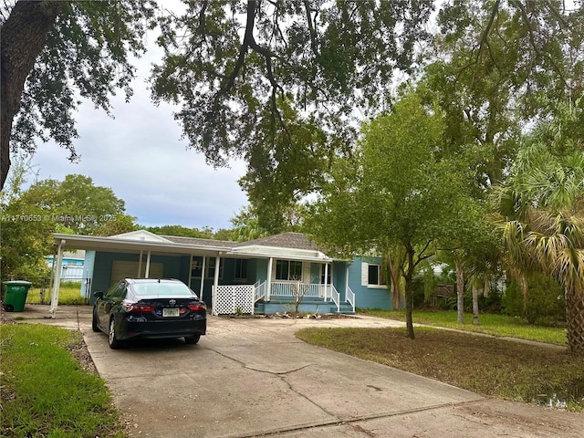 view of front of home featuring a porch and a carport