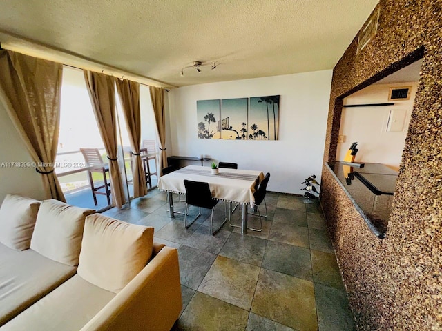 dining room featuring a textured ceiling