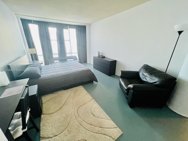 bedroom featuring carpet and a wall of windows