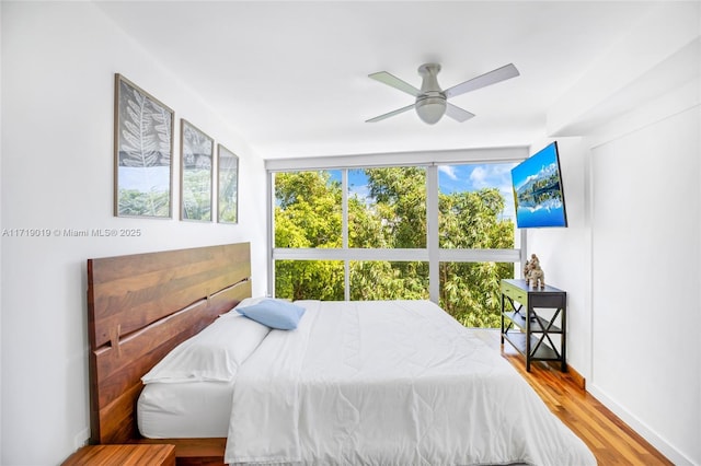 bedroom with hardwood / wood-style flooring and ceiling fan