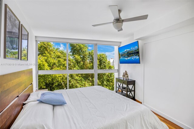 bedroom with wood-type flooring and ceiling fan