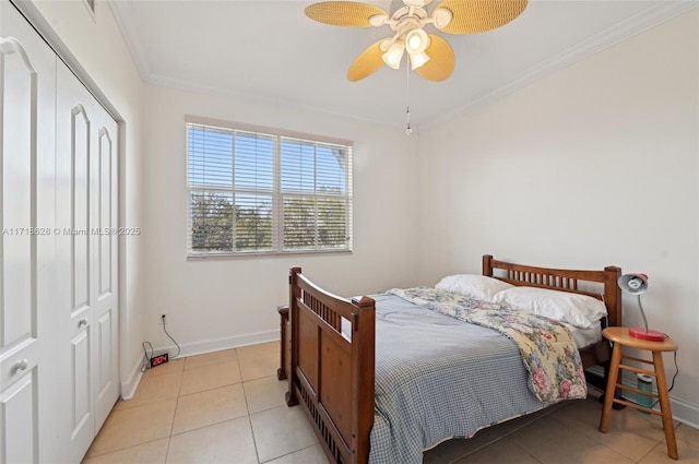 bedroom with a closet, ceiling fan, crown molding, and light tile patterned floors