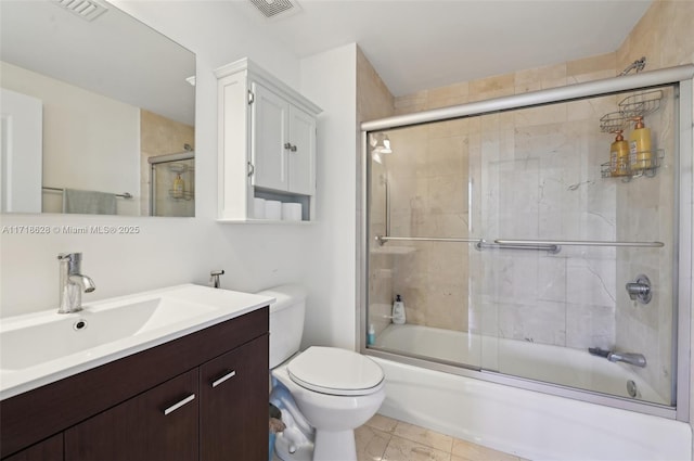 full bathroom featuring enclosed tub / shower combo, vanity, and toilet