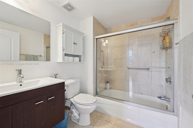 full bathroom with vanity, toilet, combined bath / shower with glass door, and tile patterned flooring