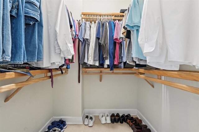 walk in closet with tile patterned floors