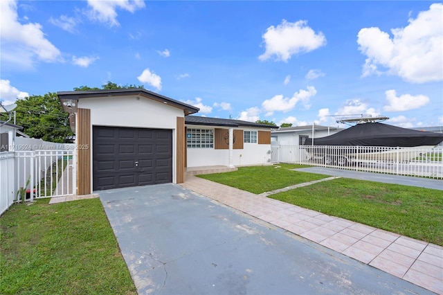 single story home featuring a garage and a front lawn