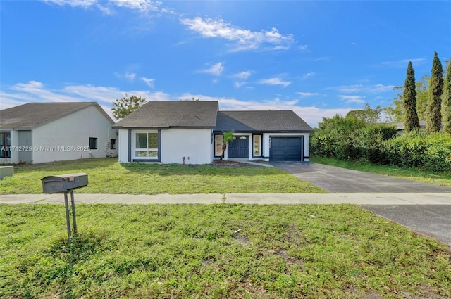 ranch-style house featuring a front lawn and a garage