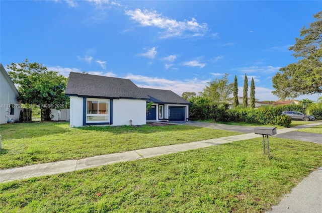 view of front of house featuring a garage and a front yard