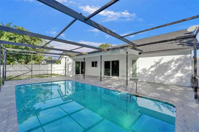 view of swimming pool featuring a lanai and a patio area