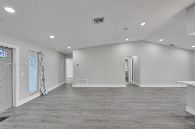 empty room featuring light hardwood / wood-style floors and lofted ceiling