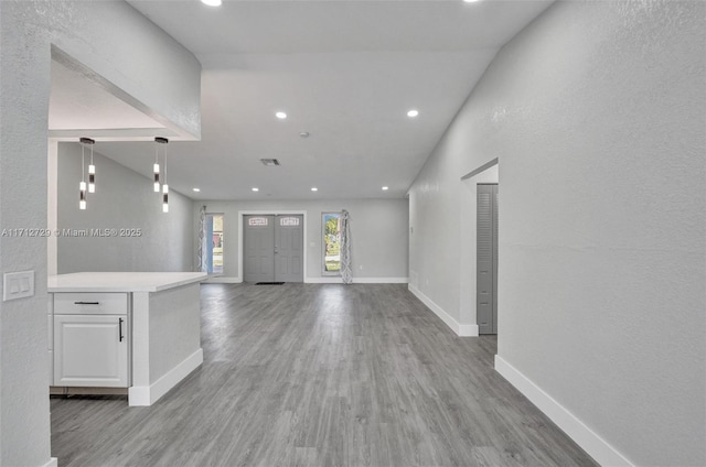 interior space with light hardwood / wood-style flooring and lofted ceiling