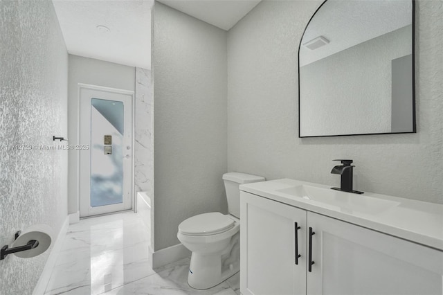 full bathroom featuring washtub / shower combination, vanity, and toilet