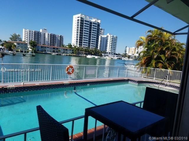 view of swimming pool featuring a lanai and a water view