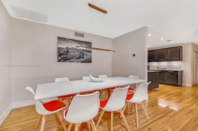 dining area featuring light wood-type flooring