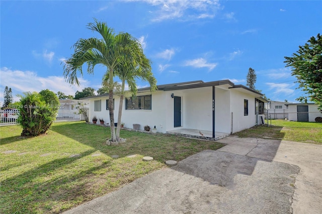 ranch-style home with a front lawn