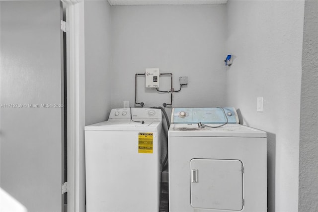 clothes washing area featuring washer and clothes dryer