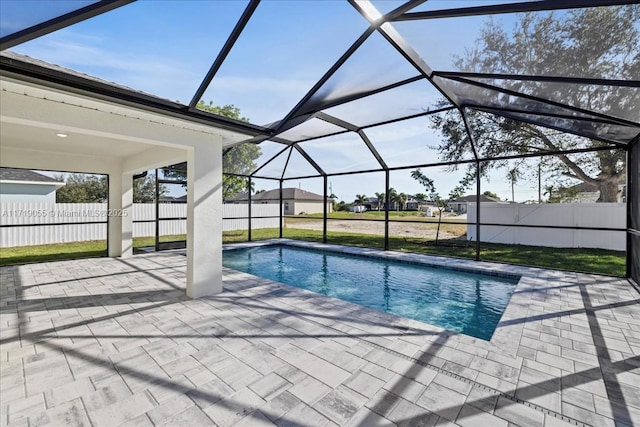 view of swimming pool featuring a patio area and a lanai