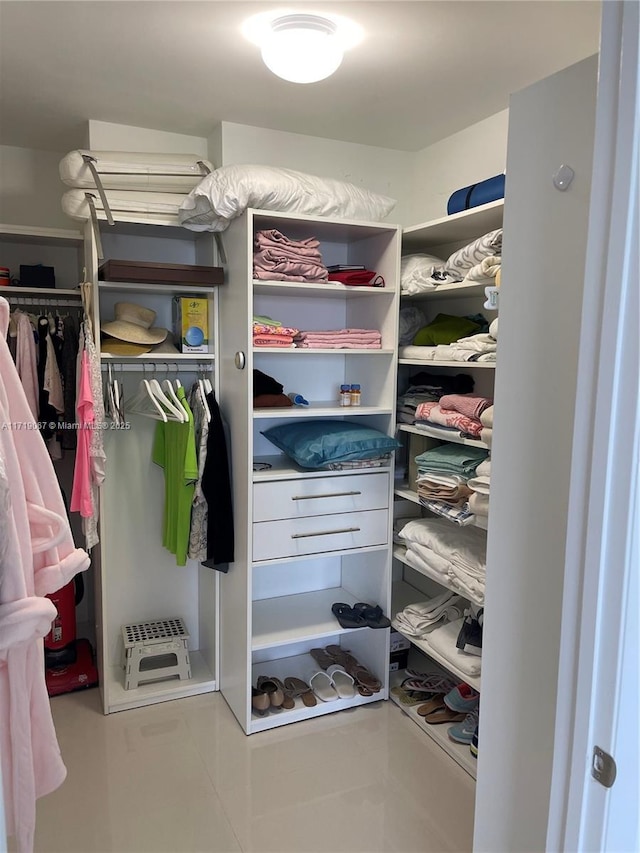 walk in closet with tile patterned flooring