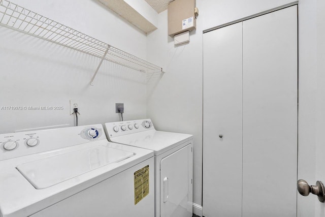 clothes washing area with washer and clothes dryer