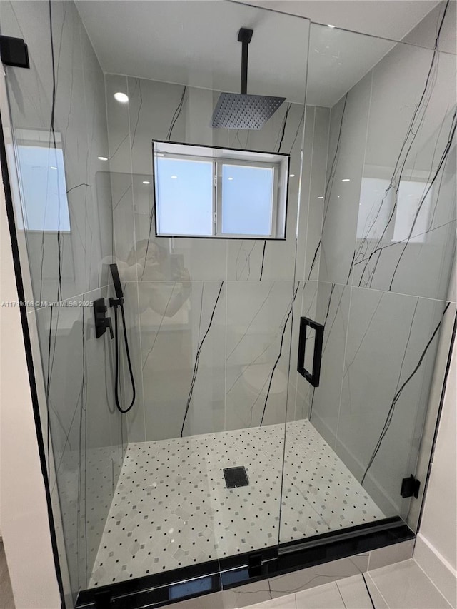 bathroom with a shower with shower door