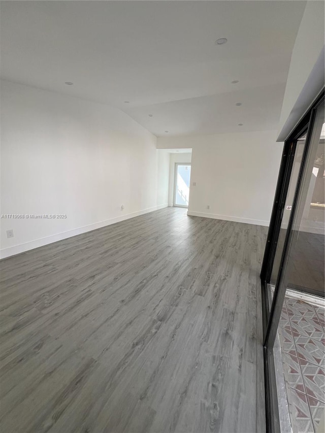 empty room with hardwood / wood-style flooring