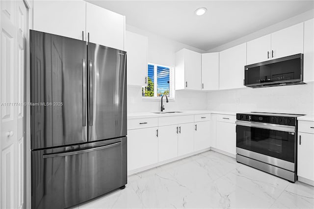 kitchen featuring white cabinets, sink, stainless steel appliances, and tasteful backsplash