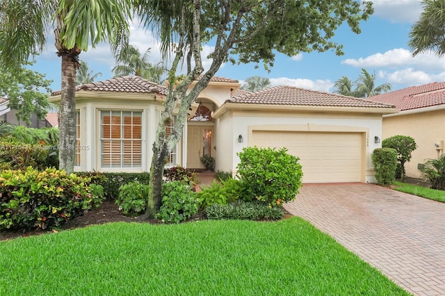 mediterranean / spanish-style home with a garage