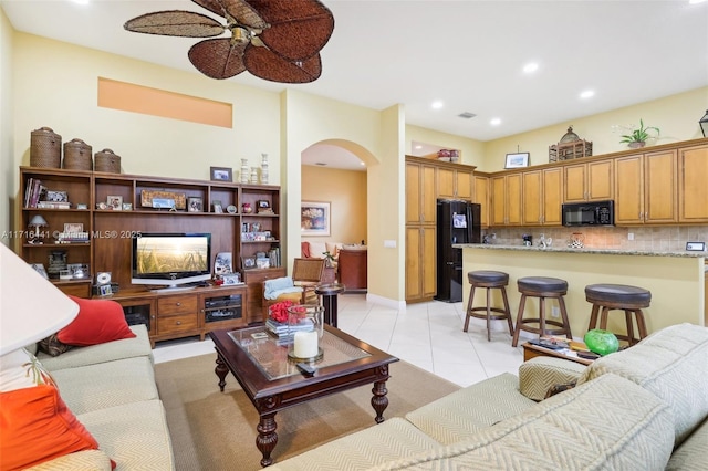 tiled living room featuring ceiling fan