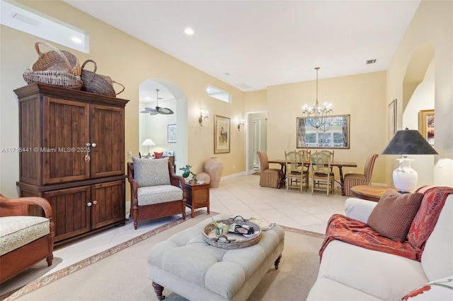 living room featuring ceiling fan with notable chandelier and light tile patterned floors