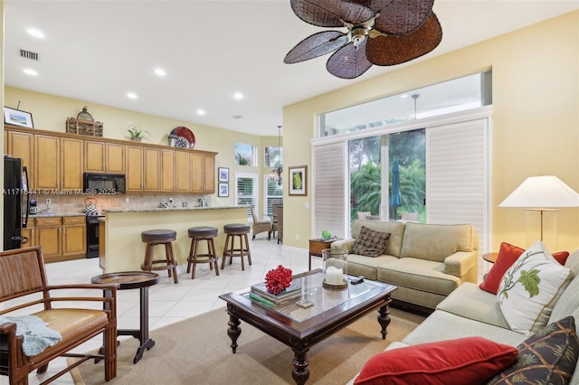 tiled living room featuring ceiling fan