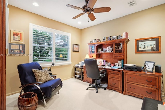 carpeted office space featuring ceiling fan