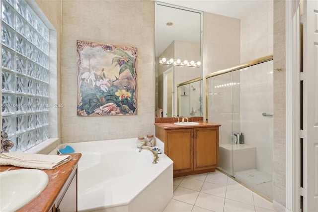 bathroom with tile patterned flooring, vanity, and separate shower and tub