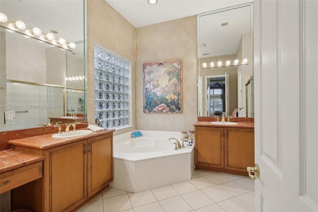 bathroom featuring vanity, a wealth of natural light, tile patterned flooring, and plus walk in shower