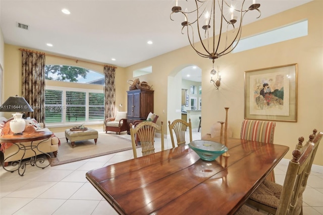 dining space featuring a notable chandelier and light tile patterned flooring