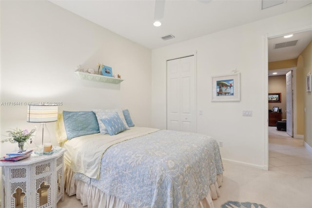 bedroom featuring light carpet and a closet