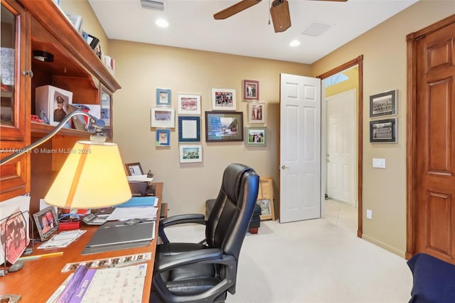 carpeted office featuring ceiling fan