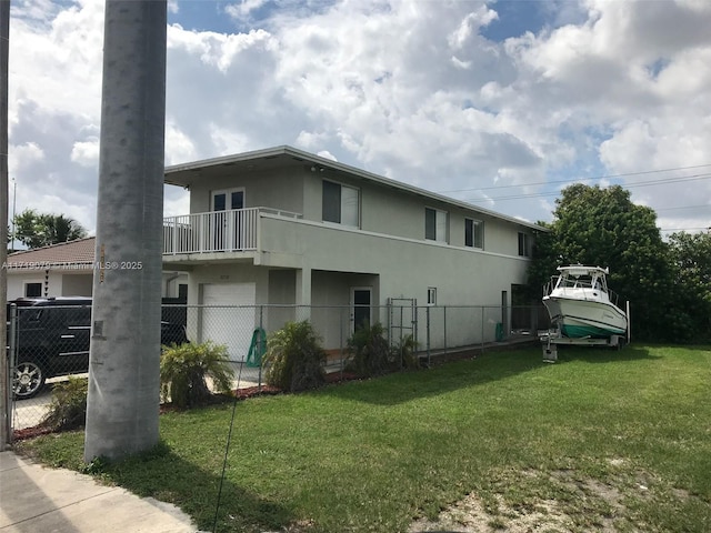 view of home's exterior featuring a yard, a balcony, and a garage