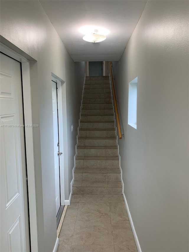 staircase with tile patterned flooring