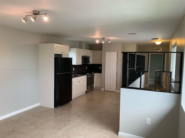 kitchen featuring white cabinets, sink, stainless steel appliances, and tasteful backsplash