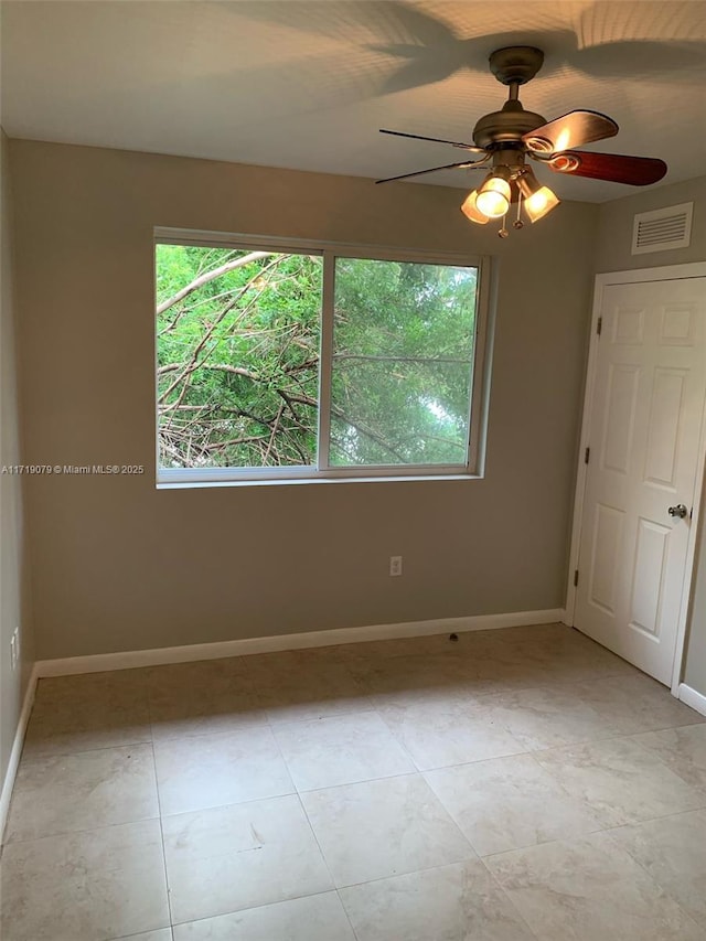 unfurnished bedroom with ceiling fan and light tile patterned flooring