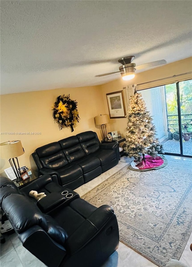 living room with a textured ceiling and ceiling fan