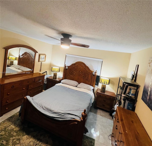 bedroom with a textured ceiling and ceiling fan