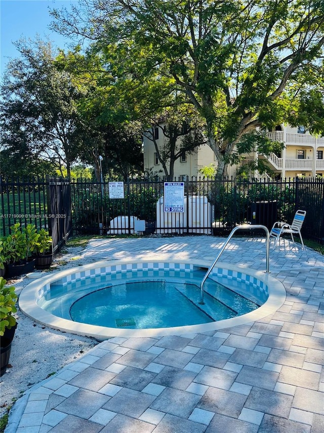 view of pool featuring a patio area and a hot tub