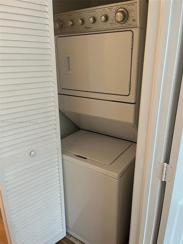 clothes washing area with stacked washer / dryer and light hardwood / wood-style floors